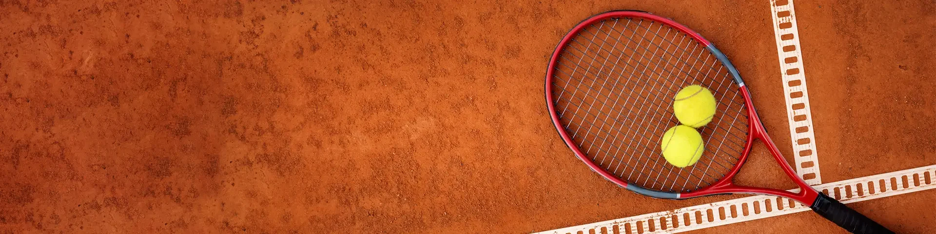 Tennisschläger mit 2 Bällen Draufsicht auf einen Tennisschläger mit 2 Bällen, die auf einem Sandplatz liegen